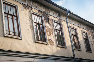 A beautiful old building remains in ruins in Russia.Windows and walls of the old building. - obrazy, fototapety, plakaty