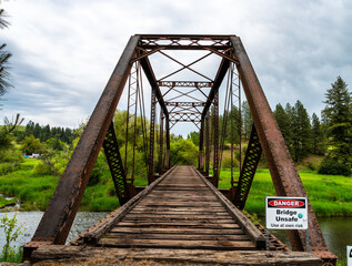 Old dangerous bridge with danger sign