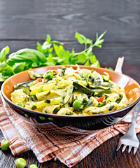 Tagliatelle with green vegetables on kitchen towel
