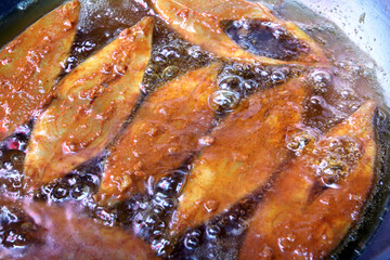 Spicy Fish is frying in oil	
