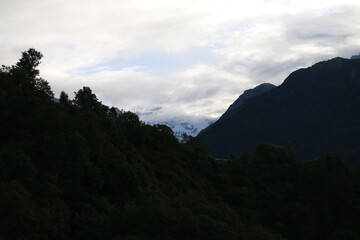 clouds over the mountain between silhouette hills