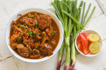 Chilli chicken curry, chicken manchurian   Mumbai, Delhi India white background. Top view of popular North Indian meat side dish for Chapati, Roti, Naan, Paratha, fried rice, Indo Chinese cuisine.