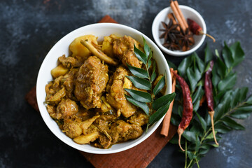 Potato chicken curry and appam home made breakfast or Chicken Aloo curry prepared in coconut milk in Kerala India. Top view of Indian non veg curry for Christmas , Easter celebration.