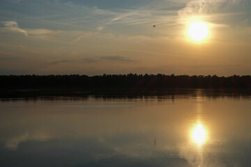 Dramatic and colorful sunset over a forest lake reflected in the water. Blakheide, Beerse, Belgium. High quality photo