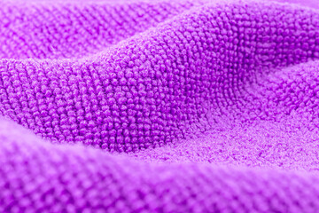 Fototapeta na wymiar Background made of purple microfiber fabric, selective focus.