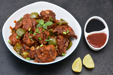 Chicken manchurian,  sweet chilli chicken, red hot and spicy curry Mumbai, Delhi India. Popular North Indian side dish for chapati, roti, naan, paratha, fried rice, pulao. Indo Chinese cuisine. 