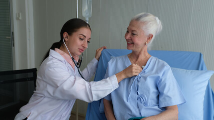 Positive minded doctor taking care of elderly woman at hospital, women doctor and elderly patient