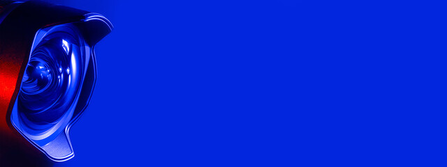 .Banner. The camera lens blue and red backlight. Close-up of the camera lens on a blue and red ...
