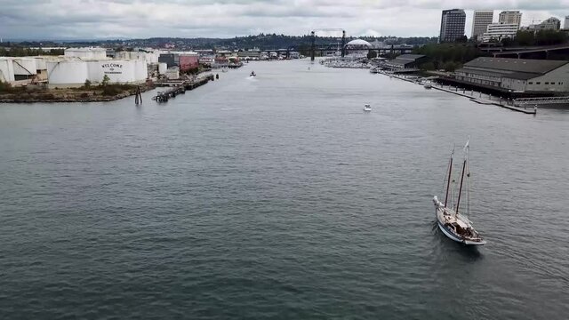Boats Sailing At The Thea Foss Waterway Entrance In Tacoma Harbor, Washington On A Cloudy Day - aerial drone slowmo
