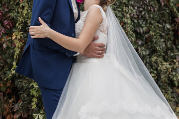 Obraz na płótnie Canvas bride and groom together in the park at wedding
