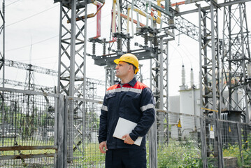 The energy engineer inspects the equipment of the substation. Power engineering. Industry.