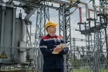 The energy engineer inspects the equipment of the substation. Power engineering. Industry.