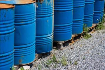 Big oil drums, blue. Chemical barrels in an open warehouse. Rusty barrels. Barrel for oil