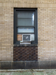 window air conditioner in old brick building