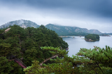 Fototapeta na wymiar Beautiful North Korean landscape of Samilpo lake with dramatic sky on the rainy day