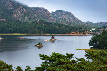 Beautiful North Korean landscape of Samilpo lake with dramatic sky on the rainy day