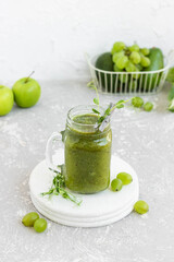 Green vitamin smoothie with shoots of young peas. Green smoothie made from apple, grape and kiwi
