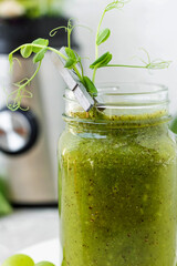 Green vitamin smoothie with shoots of young peas. Green smoothie made from apple, grape and kiwi
