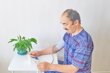 Senior man checking blood pressure