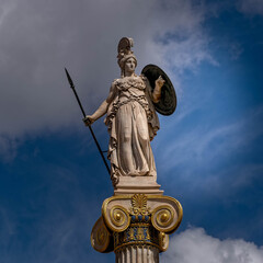 Athena, the ancient Greek goddess of wisdom and knowledge under impressive sky, Athens Greece