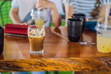 Glass Of Cold Coffee on a wooden table