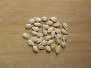 Pumpkin seeds on wood background