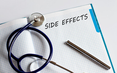 Paper with text SIDE EFFECTS on a table with stethoscope