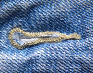 Button hole on light blue color jeans