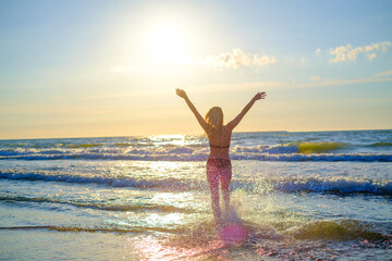 Fototapeta na wymiar Happy woman in waving sea