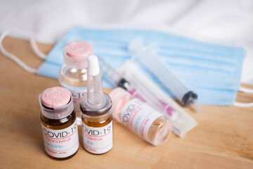 Bottle of coronavirus vaccine on table.
 Coronavirus vaccine COVID-19. 2019.   