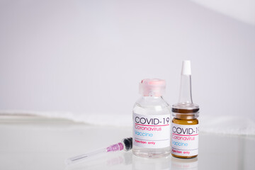 Bottle of coronavirus vaccine on table.
 Coronavirus vaccine COVID-19. 2019.   