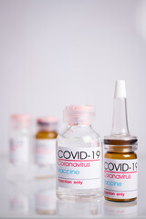 Bottle of coronavirus vaccine on table.
 Coronavirus vaccine COVID-19. 2019.   