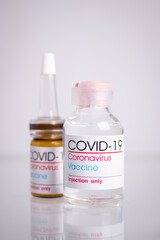 Bottle of coronavirus vaccine on table.
 Coronavirus vaccine COVID-19.