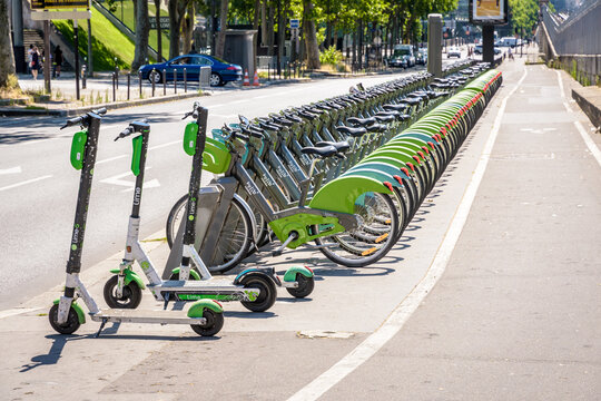 Paris, France - June 23, 2020: A fleet of about sixty Velib shared bicycles, along with three Lime electric scooters, are lined up neatly at the Velib docking station at Boulevard de Bercy.