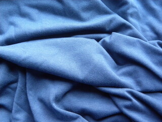 Fototapeta na wymiar Blue color cotton fabric with wrinkles