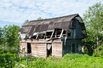 An old, burned-out wooden, dilapidated house