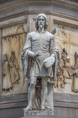 Milan, Italy – July 9, 2014: Details of monument of famous painter Leonardo and his journeymen near the Cathedral of Milano, at Milan’s historical downtown, Italy, summer time, details.