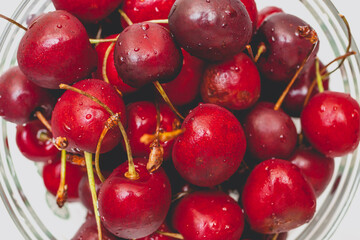 Sweet fresh red cherries in glassware. Summer lifestyle shot.