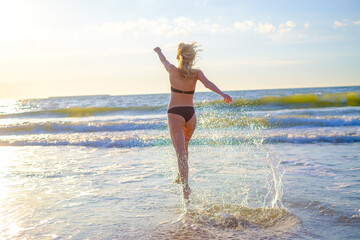 Happy woman in waving sea