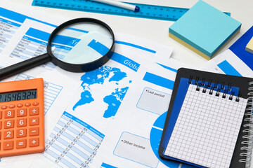 Obraz premium business office desk closeup - financial reports, analysis and accounting, set of documents, tables and graphs, various items for bookkeeping, calculator