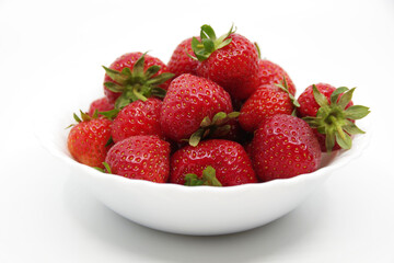 Strawberries in a bowl isolated on a white background. Red strawberries on a white background