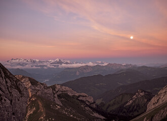 Moon rise shot taken from the peak of mount pilatus overlooking the peaks of the high alps in Switzerland.