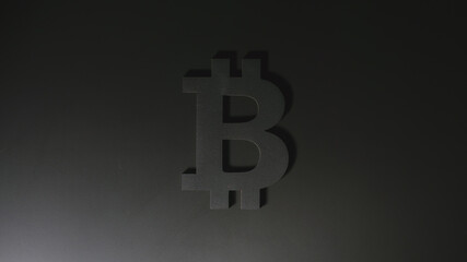 Black Bitcoin symbol on a black background