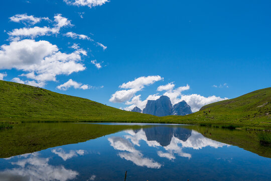 A magical panorama landscape with a lake in the mountains in the Dolomites Alps, Europe. Passo giau