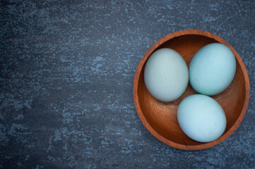 salted eggs on a wooden bowl with copy space.