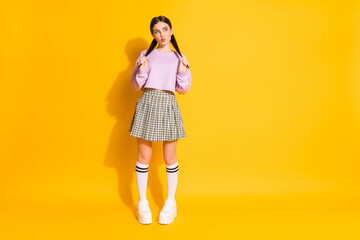 Full length photo sweet lovely girl hold tails look copyspace think thouhts guess imagine her date plans send air kiss wear jumper plaid clothes isolated bright shine color background
