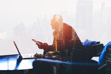 Double exposure silhouette of successful businessman is working in office company with net-book and...