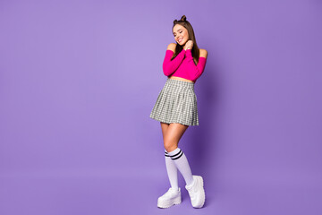 Full length photo of pretty lady eyes closed overjoyed sincere feelings hold arms together wear pink off-shoulders cropped top plaid skirt isolated pastel purple color background