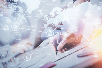 Social network theme hologram over hands taking notes background. Concept of global international people connect. Double exposure