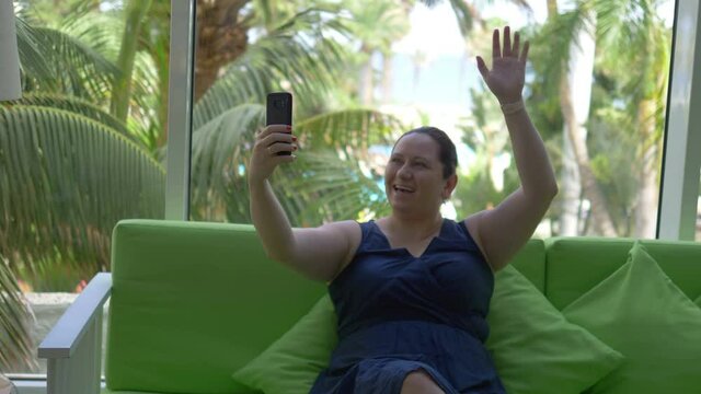 Woman taking selfie in tropical resort in 4K Slow motion 60fps